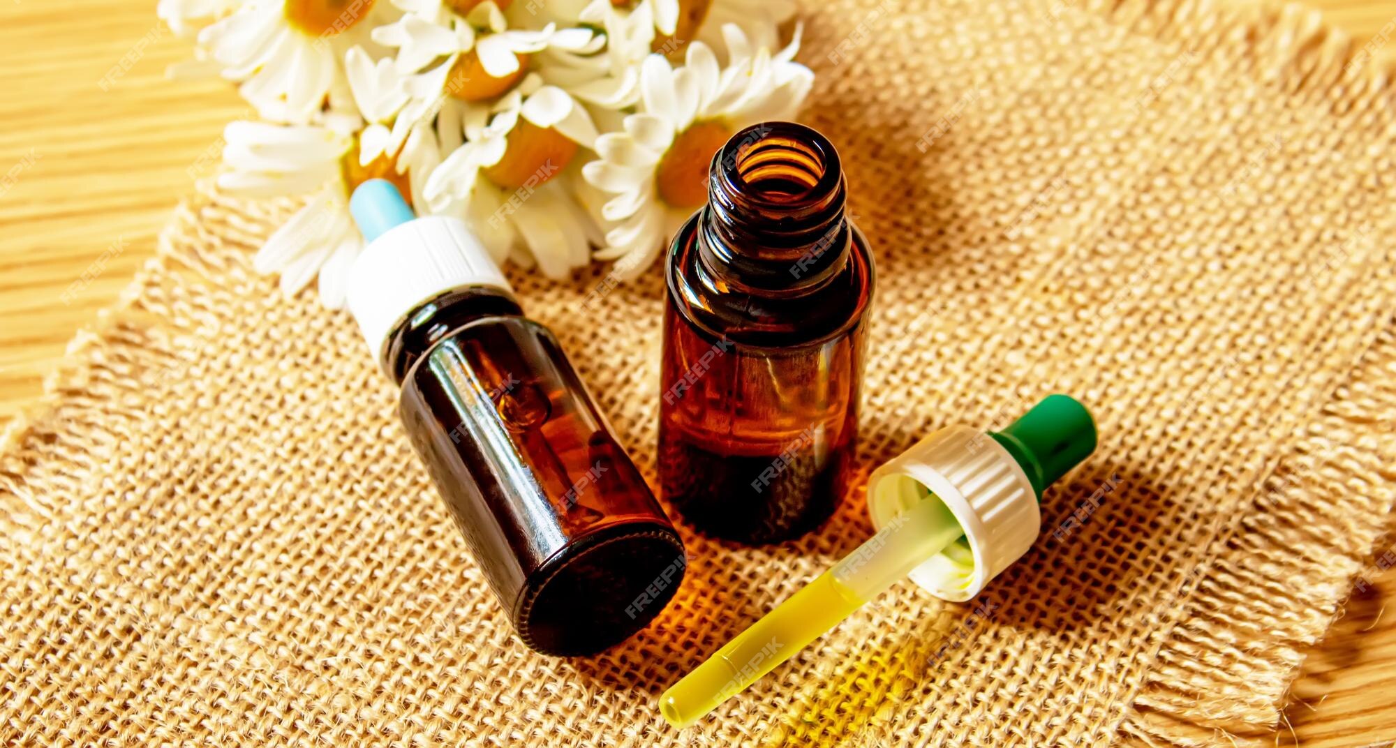 Premium Photo  Chamomile essential oil in a small bottle