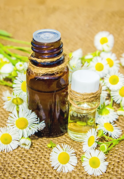 Chamomile extract in a small bottle. Selective focus.