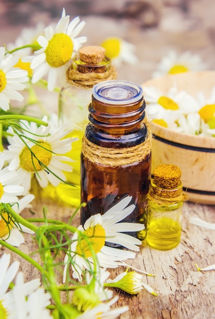 Chamomile extract in a small bottle. Selective focus.