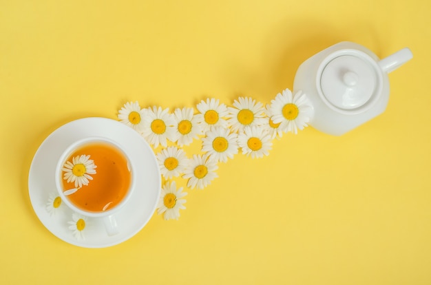 Chamomile tea is poured into a cup.