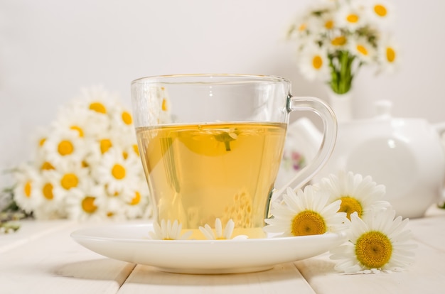 Chamomile tea in a transparent glass mug