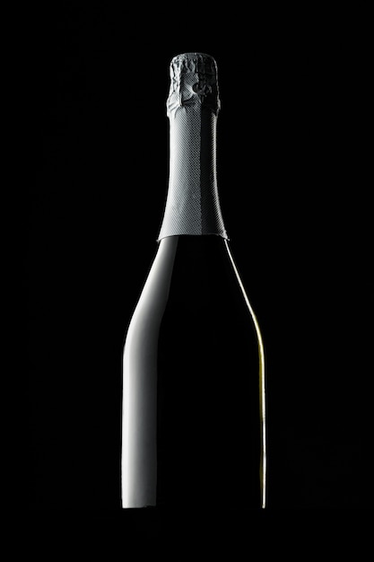 Champagne bottle on black background, copy space