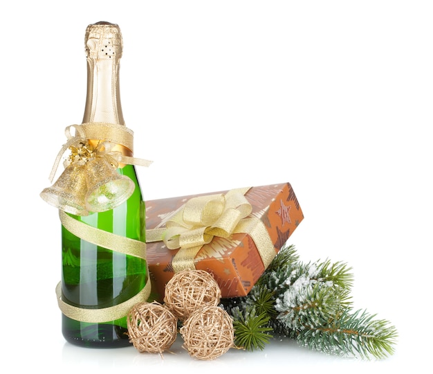 Champagne bottle, christmas gift and snowy firtree. Isolated on white background