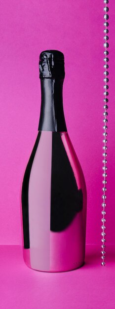 Champagne bottle on pink background