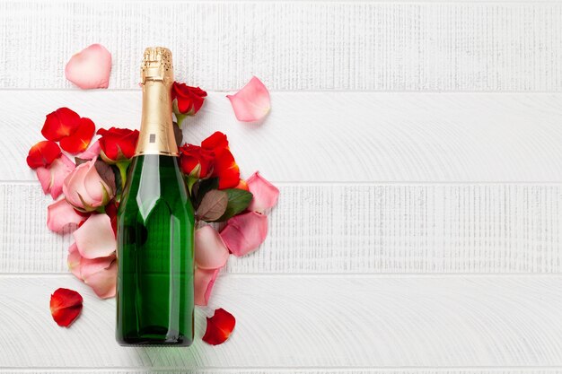 Champagne bottle and rose flowers