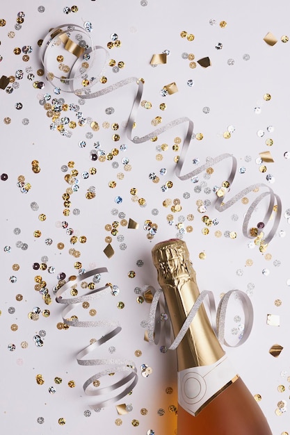 Champagne bottle with confetti ready for new year