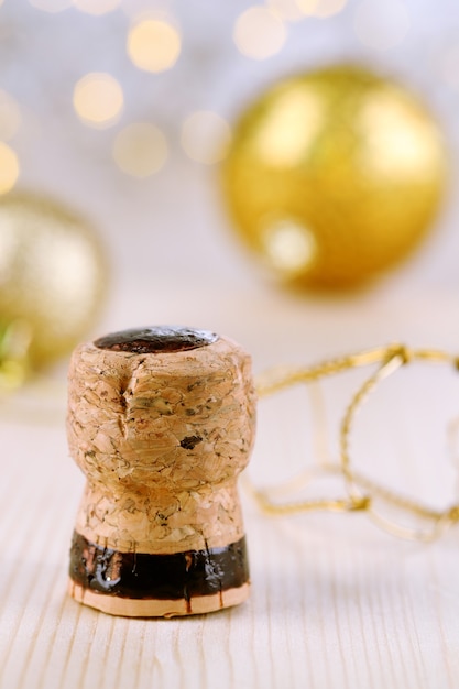 Champagne cork on Christmas lights background