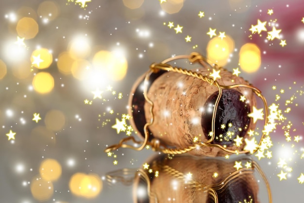 Champagne cork on Christmas lights background