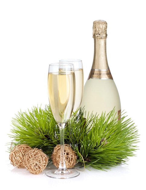 Champagne, fir tree and christmas decor. Isolated on white background