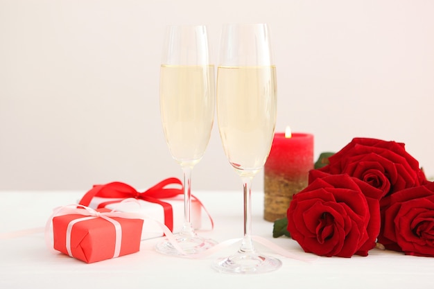 Champagne flowers and gifts on the table valentines day background