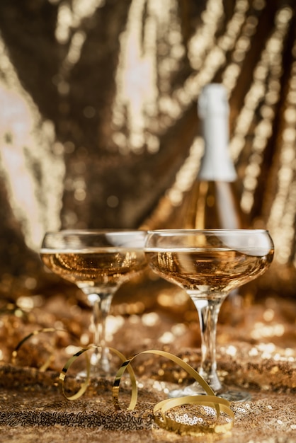 champagne flute with shiny bottle on golden shiny