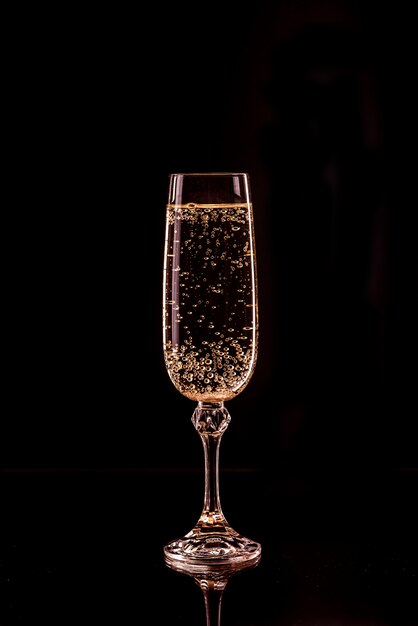 Champagne glass with bubbles with reflection