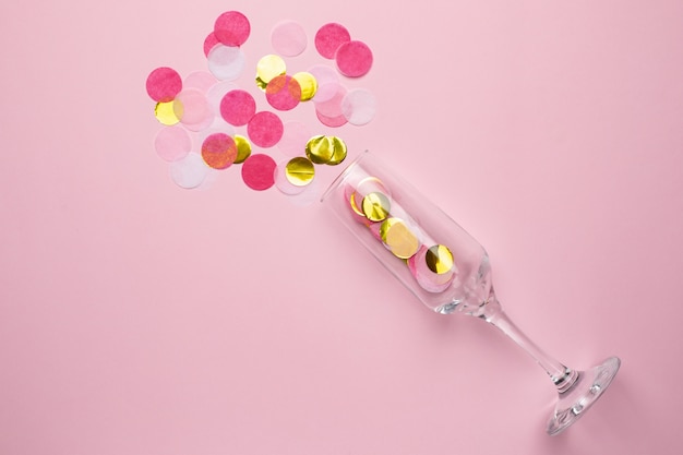 Champagne glass with golden and pink confetti