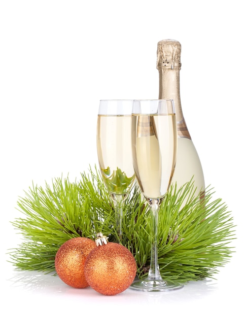 Champagne glasses, bottle, baubles and fir tree. Isolated on white background