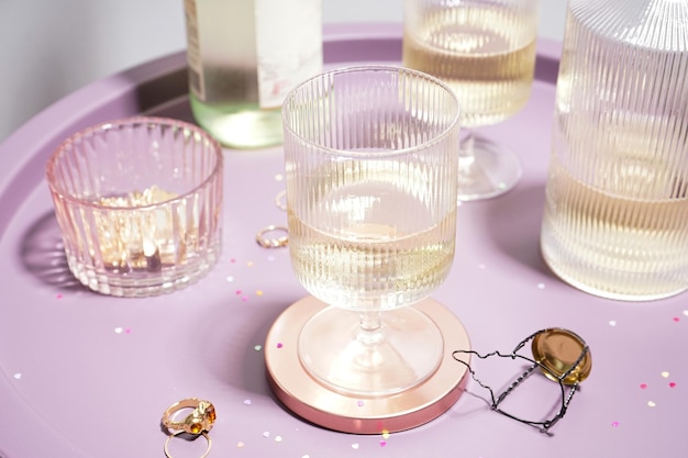 Champagne in glasses and a bottle on a table on a gray background closeup