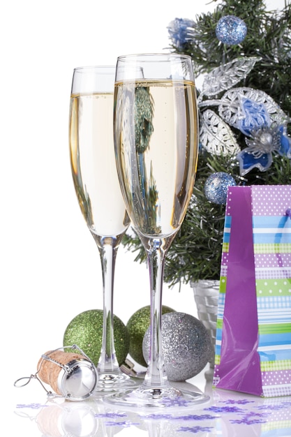 Champagne glasses, firtree and christmas decor. Closeup