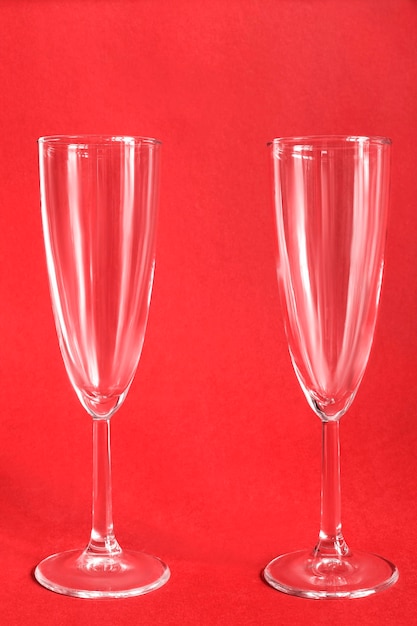 Champagne glasses on red