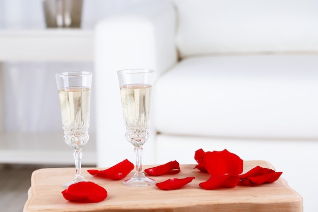 Champagne glasses and rose petals for celebrating Valentines Day