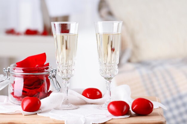 Champagne glasses and rose petals for celebrating Valentines Day