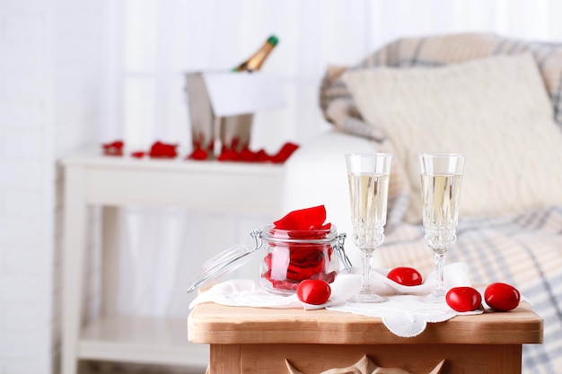 Champagne glasses and rose petals for celebrating Valentines Day