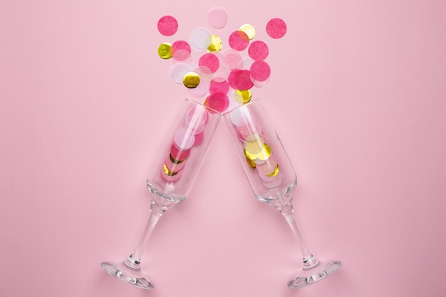 Champagne glasses with golden and pink confetti