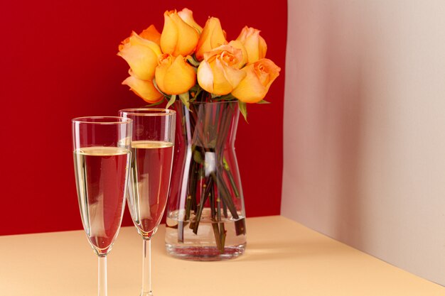 Champagne glasses with roses in a vase