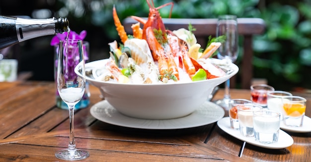 Champagne pouring with luxury bowl of seafood