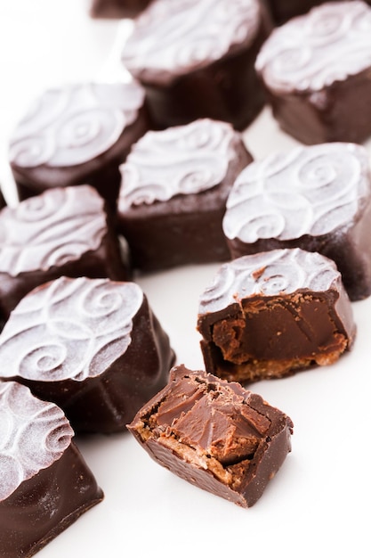 Champagne truffles with silver dust on a white background.