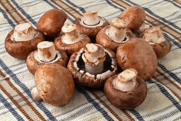 Champignon mushrooms on a towel Brown champignons A bunch of mushrooms Natural dietary products