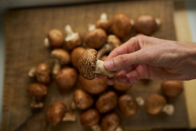 Champignon mushrooms on a wooden board Fresh healthy brown mushrooms
