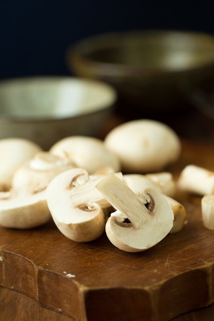 Champignon mushrooms on the wooden table