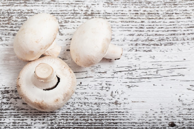 Champignon on wooden background