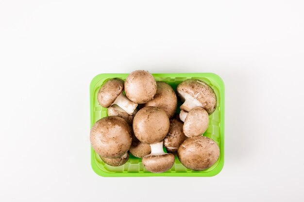 Champignons mushrooms in the pack, isolated on white.