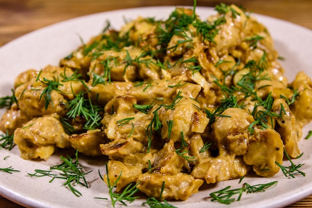 Champignons stewed in sour cream on a plate