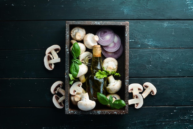 Champignons with spices on the old kitchen table Top view Free space for text