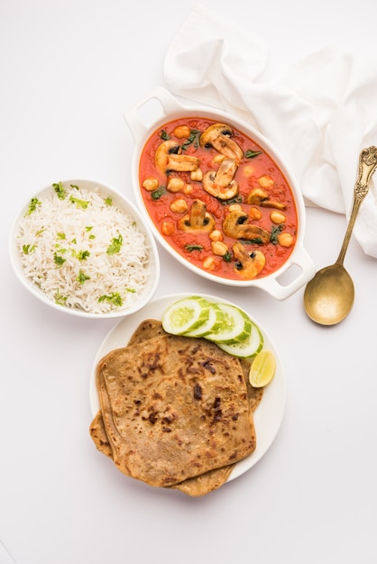 Champignonsabzi in tomatencurry met kikkererwten en spinazie, Indiaas hoofdgerecht menu geserveerd met Paratha en gekookte witte rijst
