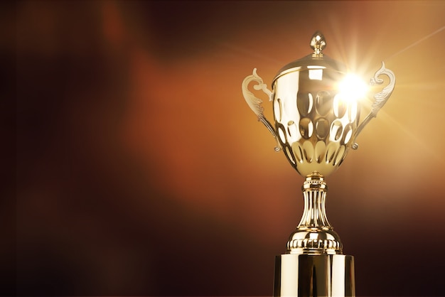 champion golden trophy placed on wooden table