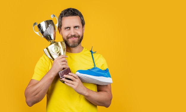 Champion man hold award in studio advertisement photo of champion man