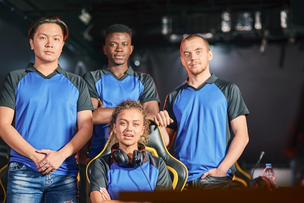 Champions. Group of multiracial cybersport gamers looking at camera, participating in eSport tournament. Online video games competition