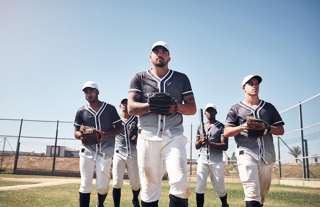 Photo the champs are here shot of a group of young men walking onto a baseball field