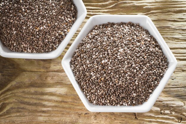 Chan beans in bowl on old wooden background Salvia hispanica