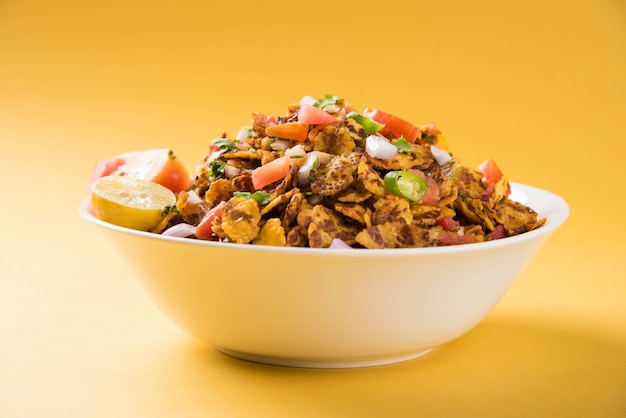 Chana chor jor garam - Indian roadside spicy chat or snack food, served in a plate or bowl over colourful or wooden background. Selective focus