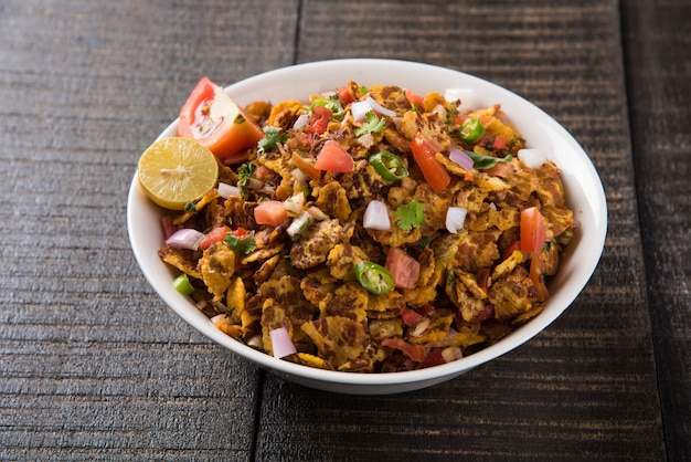 Chana chor jor garam - Indian roadside spicy chat or snack food, served in a plate or bowl over colourful or wooden background. Selective focus