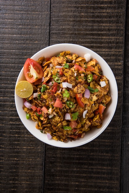 Chana chor jor garam - Indian roadside spicy chat or snack food, served in a plate or bowl over colourful or wooden background. Selective focus