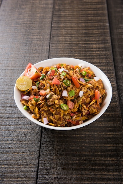 Chana chor jor garam - 인도 길가의 매운 잡담이나 스낵 음식은 다채롭거나 나무 배경 위에 접시나 그릇에 제공됩니다. 선택적 초점