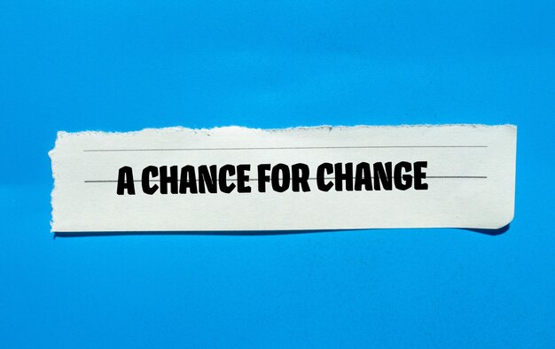 A chance for change words written on torn paper piece with blue background Conceptual symbol