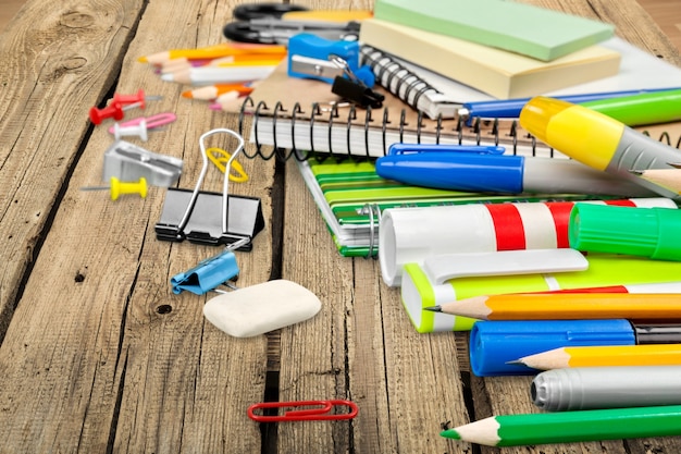 Photo chancellery on wooden table. notebooks, pens, sharpeners