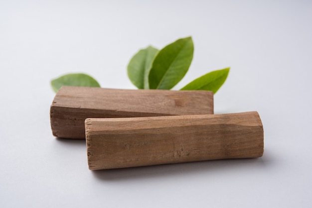 Chandan or sandalwood dried sticks or piece with green leaves. selective focus