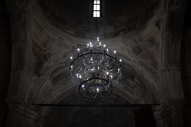 a chandelier in a church with a window