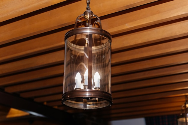 Chandelier hanging from the wooden ceiling in retro style